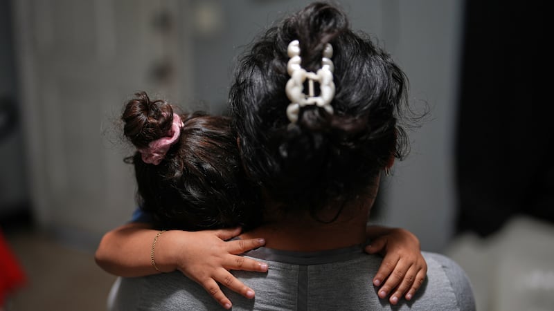 Yaoska, una solicitante de asilo embarazada de 32 años, consuela a su hijo de dos, que no se...